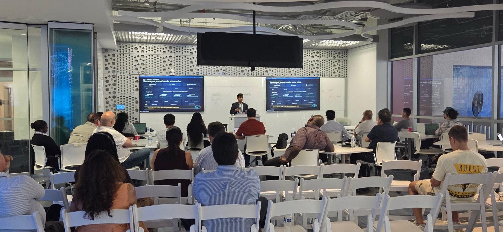 Abhi Puttanna presenting The Trading Bots That Ate My Tokens to a full room at Miami Dade College